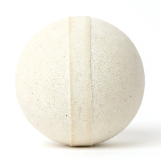 Round, cream-colored Cleopatra bath bomb with a textured oatmeal finish and a smooth center band on a white background.
