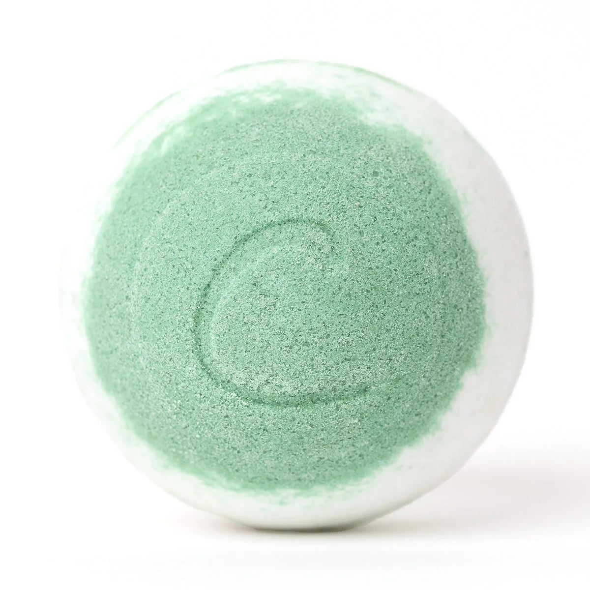 Round white and lime green bath bomb with a textured surface and a subtle letter C embossed on the front.